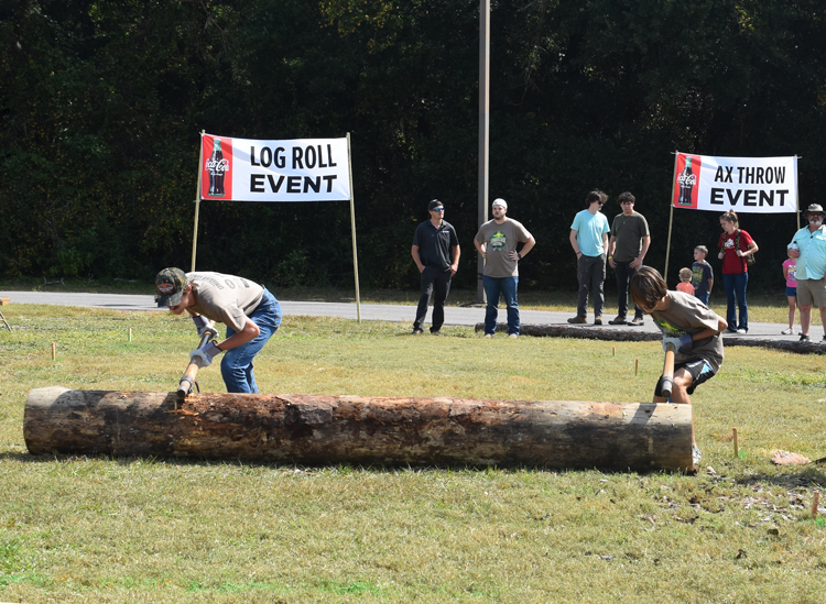 decorative image of log-roll , Lumberjack Festival brings crowd to Milton campus – some to cut logs and throw axes, some to run through woods, others just to watch 2022-10-20 09:26:03