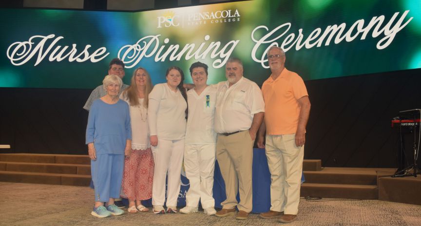 Nurse pinning couple with family decorative image of Nurse-pinning-couple-with-family-scaled , More than 80 PSC nursing students pinned at ceremony 2024-05-16 09:35:56